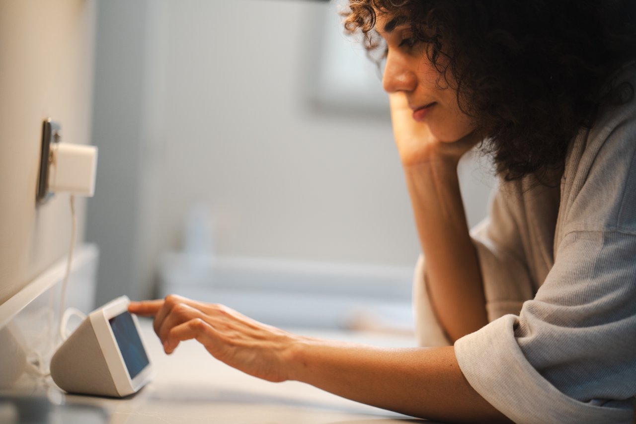 Woman using a device plugged into a smart plug