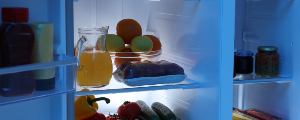 fridge freezer with fruit and vegetables inside