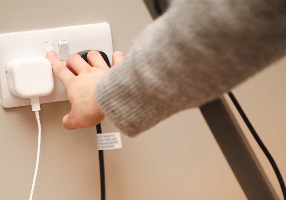 Person unplugging an appliance