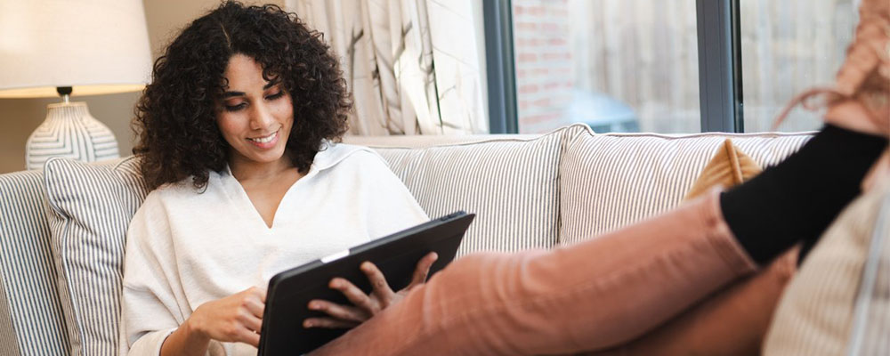 Woman on a sofa using tablet